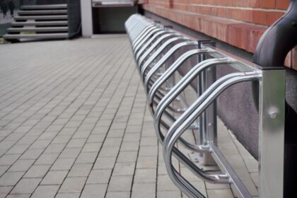 New,Empty,Metal,Parking,For,City,Bikes,Near,Red,Brick