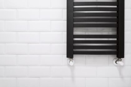 Closeup,Of,Modern,Metal,Radiator,On,Ceramic,Brick,Tile,Background