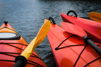 Red,Kayaks,And,Paddle,On,River