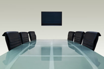 Meeting,Room,With,Glass,Top,Table,,,Armchairs,And,Television.