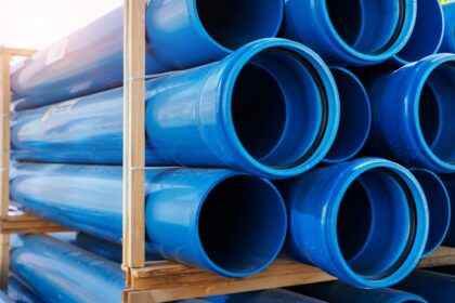 Close-up,Blue,Pvc,Plumbing,Pipes,Stacked,Wooden,Pallets,Replacement,At