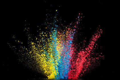 Explosion of colored powder isolated on black background.