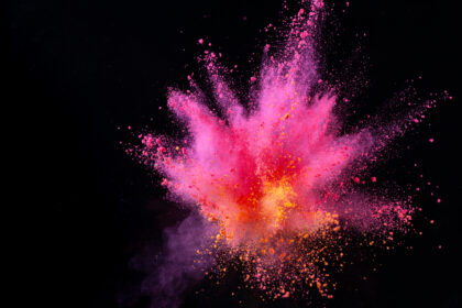 colorful powder explode on black background captured in high speed
