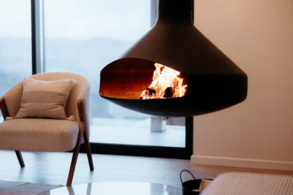 Modern hanging fireplace burning in a minimalist cabin interior design