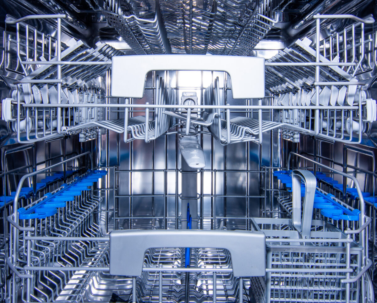 Front view of modern stainless steel dishwasher interior.
