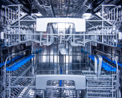 Front view of modern stainless steel dishwasher interior.