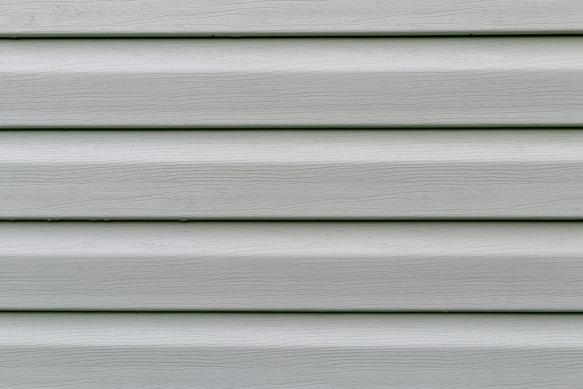 The surface of the pistachio plastic siding is a close-up as a background. Abstraction.