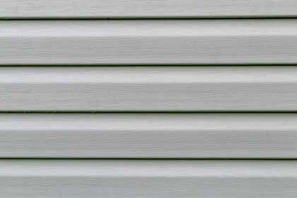 The surface of the pistachio plastic siding is a close-up as a background. Abstraction.