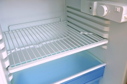 Close-up of an open and empty clean fridge