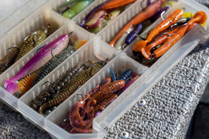 Fishing tackles and fishing baits in box .Classic Colored Fishing Lure , Beautiful Background digital image.Fishing on the lake at sunset.