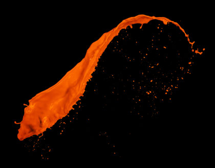 Orange paint splash on black background