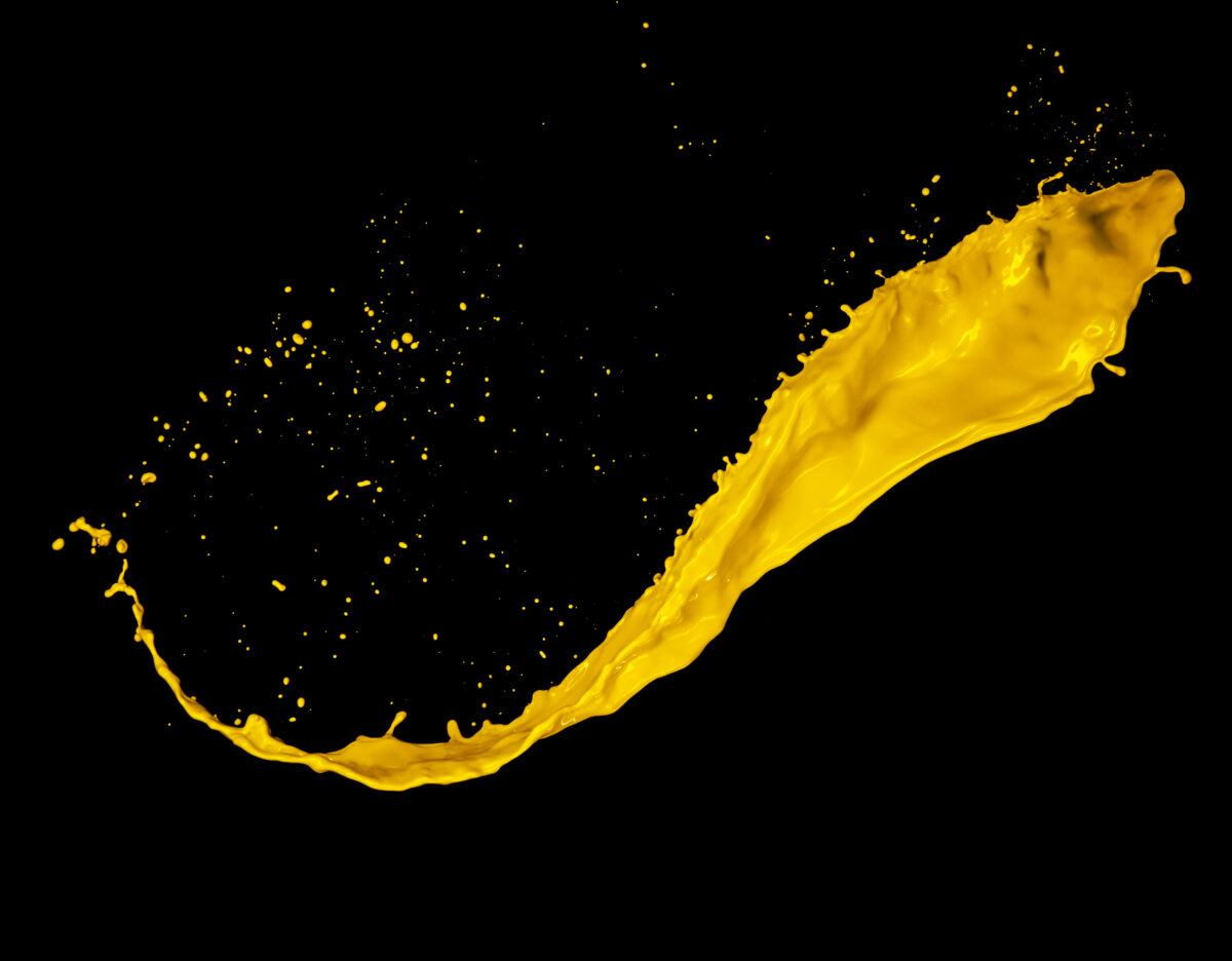 Yellow paint splash on black background