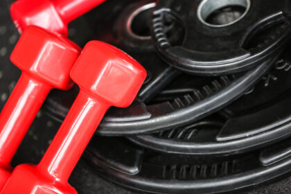 Weight,Plates,And,Dumbbells,In,Gym,,Close,Up