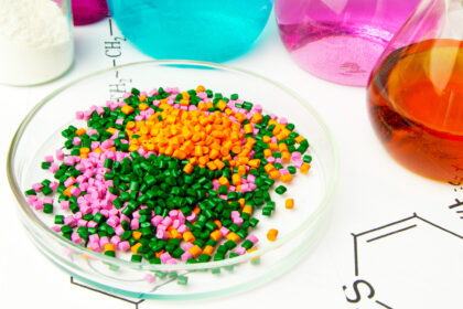 Plastic raw material in granules against the background of Chemical Laboratory and reagents. Polypropylene, Ethylene, Polypropylene research in laboratory conditionsPlastic raw material in granules against the background of Chemical Laboratory and reagent