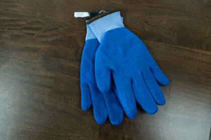 Blue safety protection gloves in factory workshop