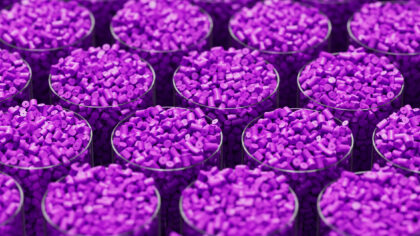 Grid of glasses filled with purple plastic polypropylene granules, masterbatch polymer grain, with shallow DOF. HDPE or PVC resin pellets. 3d render illustration